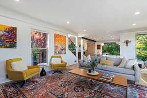 Living area featuring recessed lighting, stairway, wood finished floors, and baseboards