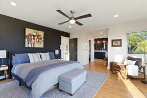 Bedroom with light wood-type flooring, recessed lighting, a ceiling fan, and baseboards