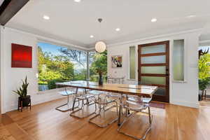 Dining area featuring light wood finished floors, baseboards, and recessed lighting