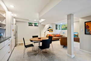 Dining space featuring light colored carpet, recessed lighting, and baseboards