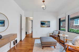 Sitting room featuring light wood-style flooring and baseboards
