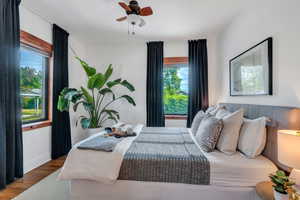 Bedroom with wood finished floors, baseboards, and a ceiling fan