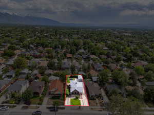 Aerial perspective of suburban area featuring mountains and property boundaries highlighted