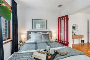 Bedroom featuring wood finished floors and baseboards