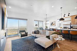 Living room featuring light wood finished floors and recessed lighting