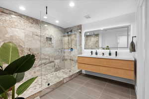 Full bath featuring double vanity, walk in shower, tile patterned floors, and recessed lighting