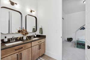 Ensuite bathroom with double vanity and baseboards
