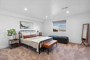 Bedroom with light colored carpet, baseboards, and recessed lighting