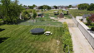 View of yard featuring a trampoline and a residential view
