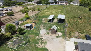 Aerial view of property and surrounding area with nearby suburban area
