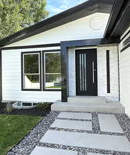 Custom front entry blending marble stone and steel.