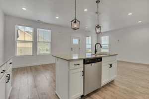 Kitchen featuring stainless steel dishwasher, a sink, light wood-style floors, pendant lighting, and recessed lighting. Beautiful mountain and field views visible from all windows.
