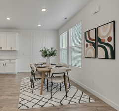 Dining room with recessed lighting and light wood-style flooring