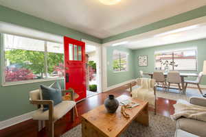 Living area with baseboards and wood finished floors
