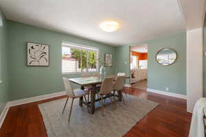 Dining area with baseboards and wood finished floors