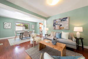 Living room featuring baseboards and dark wood-type flooring