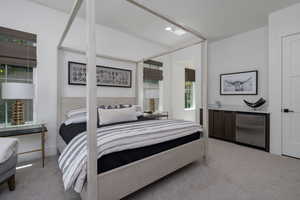 Carpeted bedroom with fridge