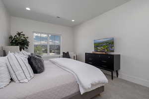 Bedroom featuring light colored carpet and recessed lighting