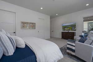 Bedroom with light colored carpet, recessed lighting, and baseboards