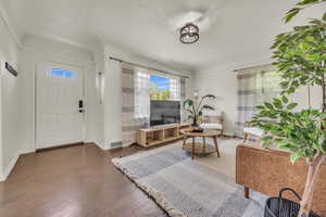Living room with wood finished floors and baseboards