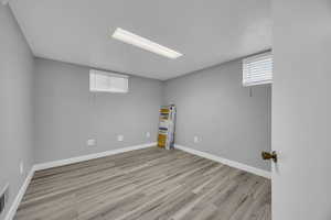 Below grade area with wood finished floors and baseboards
