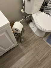 Bathroom featuring wood finished floors and toilet