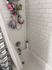 Full bath featuring shower / bathtub combination with curtain
