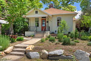 Bungalow-style home featuring covered porch and a chimney