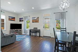 Living area featuring crown molding, plenty of natural light, hardwood / wood-style flooring, baseboards, and recessed lighting