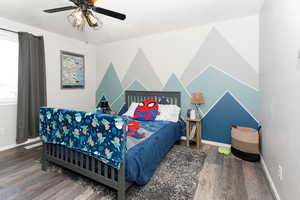 Bedroom featuring wood finished floors, baseboards, and ceiling fan