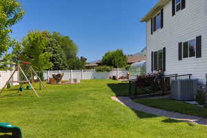 View of yard featuring cooling unit and a playground
