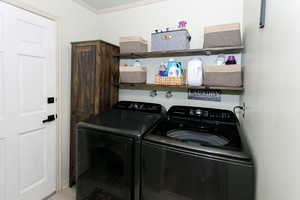Laundry room with independent washer and dryer and crown molding