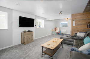 Carpeted living area featuring baseboards and a textured ceiling
