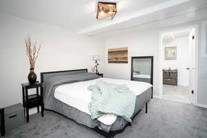 Bedroom featuring carpet floors and baseboards