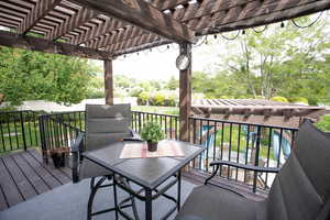 Wooden deck featuring a pergola