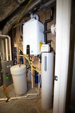 Utility room featuring tankless water heater