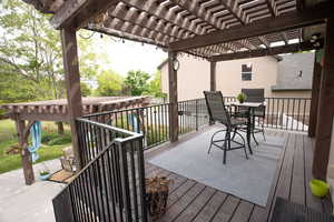Wooden terrace with a pergola and outdoor dining space