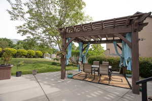 View of patio with a pergola and outdoor dining space