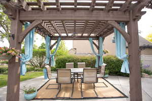 View of patio featuring a pergola and outdoor dining area