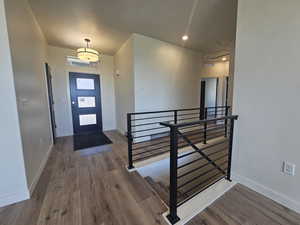 Foyer entrance featuring wood finished floors and baseboards