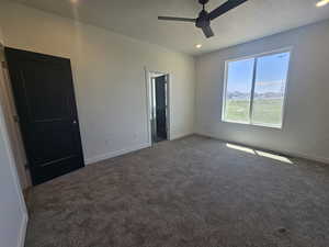 Unfurnished bedroom with carpet floors, baseboards, a textured ceiling, recessed lighting, and ceiling fan