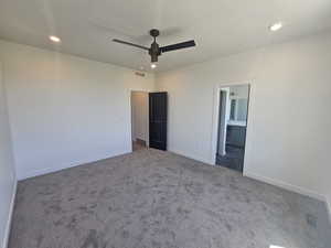 Unfurnished bedroom featuring carpet, baseboards, recessed lighting, ensuite bath, and ceiling fan