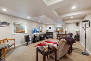 Carpeted living room featuring recessed lighting and baseboards