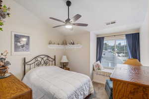 Bedroom with carpet, lofted ceiling, baseboards, and a ceiling fan