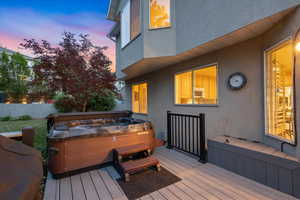 Deck at dusk with a hot tub
