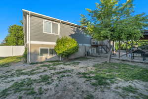 View of back of property with fenced backyard, a patio