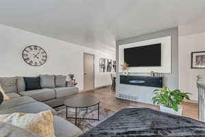 Living area with contemporary laminate flooring and baseboards