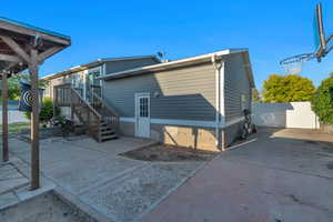 View of back of property with fenced backyard, a patio, a small deck, and RV parking