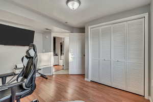 Bedroom used as a home office featuring contemporary laminate flooring and baseboards