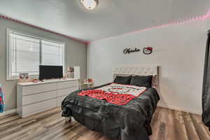 Bedroom with contemporary laminate flooring and baseboards